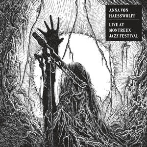 Cover art of Anna Von Hausswolff's Live at Montreux Jazz Festival.
It depicts a woman with a raised hand, singing into a microphone.
The art is drawn in black and white.
In the background there is a large iris of an eye, surrounded by roots and branches.
The branches grow into the woman's face.