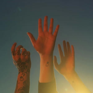 Cover art of boygenius' the record.
It depicts three raised hands.
Each arm is also tattooed with a tooth.
The left hand, belonging to Julien Baker, has a lot of other tattoos and shows the back of her hand.
The middle hand, belonging to Lucy Dacus, is showing the palm.
The right hand, belonging to Phoebe Bridgers, also shows the palm.
Phoebe also has a thin ring on her pink.